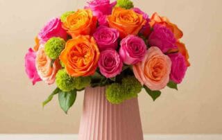 roses in shades of orange, hot pink and light pink with bright green accents. This beauty is sure to be a crowd pleaser.